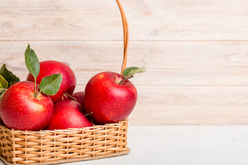 Ripe red apples in wooden box. On a white wooden background