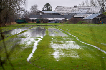 Farm Field Spring Flooding. Heavy rains cause a flooded, muddy farm field in Springtime.

