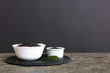 quinoa seeds in bowl on colored background. Healthy kinwa in small bowl. Healthy superfood