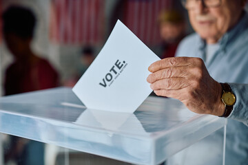 Close up of senior citizen voting during US elections.