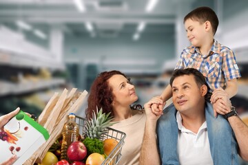Happy family shopping in big supermarket