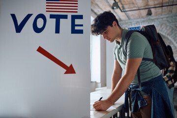 Young man at voting booth during United States of America elections.