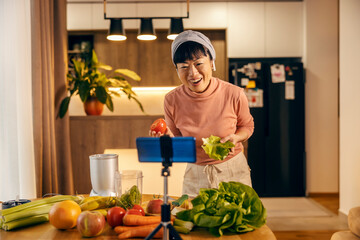 A japanese middle aged woman is live streaming and cooking healthy food.
