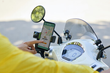 Motorbike taxi driver accepting new request via mobile application