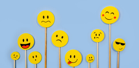 Wooden pallets with various emoticons together, happy, sad, surprised, scared. Concept of moods and psychology. copyspace