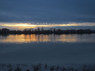 Tranquil scenery sunset Sava river Sremska Macvanska Mitrovica, Serbia. Perfect reflection of trees...