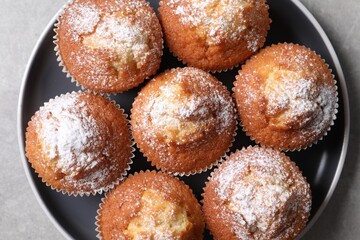 Delicious sweet muffins on light grey table, top view