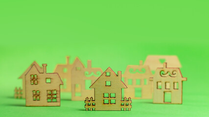 Model of the wooden house on green background. concept of sell of house, architecture. copyspace