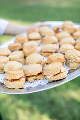 person holding tray of biscuits