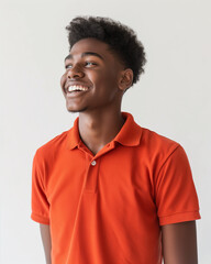 Portrait of a handsome smiling young black man wearing orange blouse, isolated on white background. Positive emotions concept