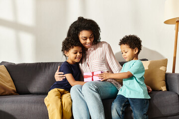 attractive merry african american woman receiving present from her two cute children, Mother day