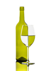 A colorful bottle with reflections in a wine glass
