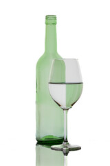 A colorful bottle with reflections in a wine glass
