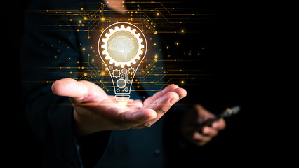 Concept of new ideas and innovation, businessman hand holding light bulb with inspiration on...