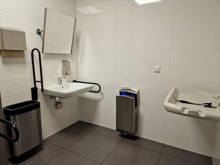 public toilet for disabled people and mothers with children. Baby changing station
