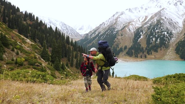 Father and son trekking in the mountains. Interesting family pastime. Healthy lifestyle in outdoors
