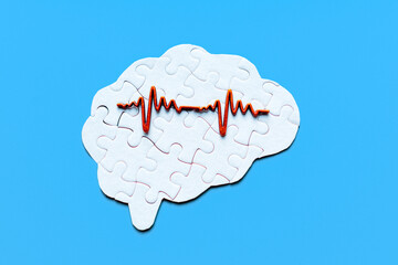 Brain Puzzle with Heart Rate Signal on Blue