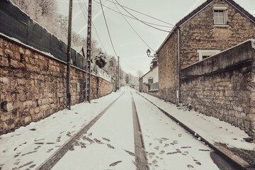snow covered street in village