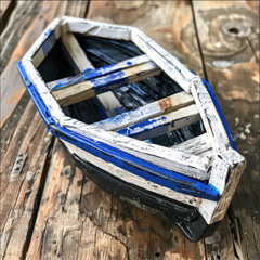 Model of a wooden boat in white and blue colors
