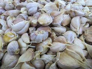 fresh garlic in the market, food background. Piles of garlic have a pungent odor and are one of the spices in cooking