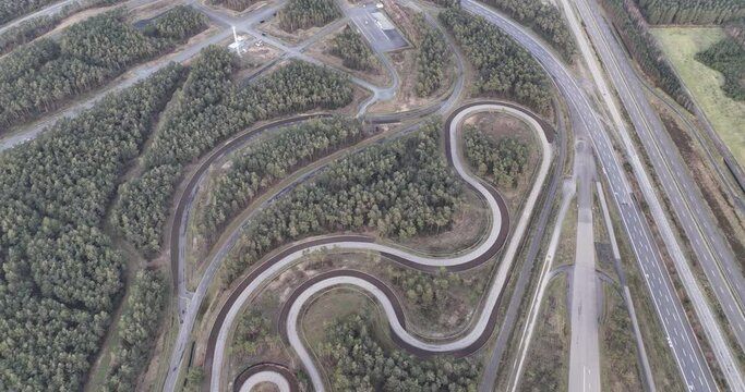 Aerial drone view on test track for the mobility industry. Test driving area circuit. Turns corners straights on asphalt.