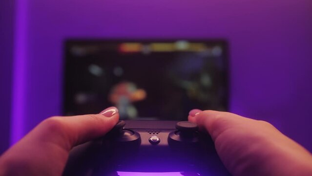 Woman playing game online at home. Gamer girls controlling joystick for video game.