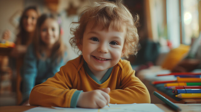 Portrait of happy child drawing with pencils