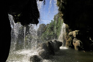 interior of a rocky waterfall cave in Vincennes park