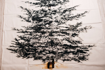 A detailed black and white print of a spruce tree with a rustic wood background.