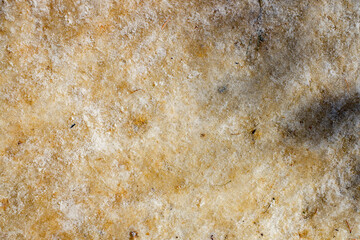 background of an icy road sprinkled with sand in winter
