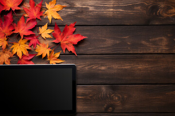 Laptop on a black wooden background with autumn leaves сreated with Generative Ai - obrazy, fototapety, plakaty