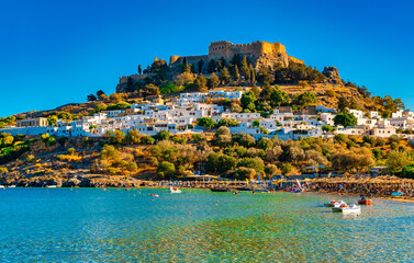 View of the Acropolis of Lindos and the city from the beach. - obrazy, fototapety, plakaty
