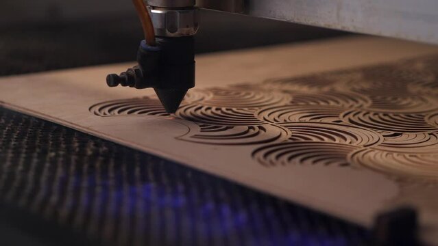 The laser cuts the plywood, wood heats up and smokes. new technologies 