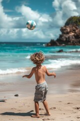 Blonde boy playing with a ball on the beach
