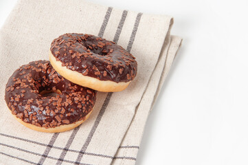 Chocolate donuts on a tablecloth