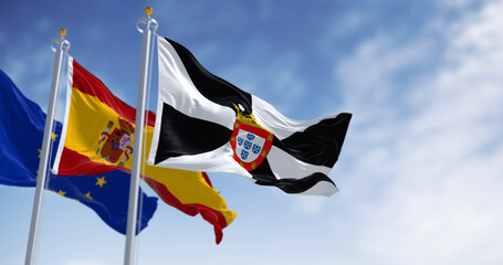 Ceuta and spanish national flags waving on a clear day