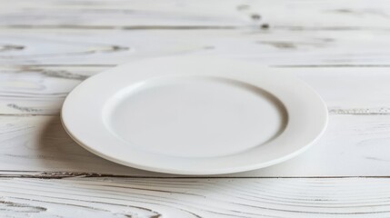 Empty white plate on rustic wooden background. Clean ceramic dish on shabby chic wood. Simple table setting in minimalist style.