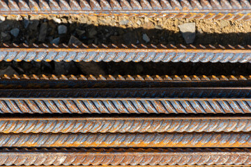 Steel reinforcement bars. Construction rebar steel work reinforcement. Industrial background. Stack of iron bars