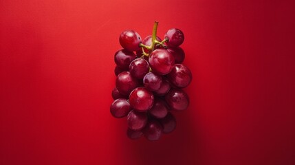 Red grapes on a red background. Food and drinks, ingredients. Healthy eating.