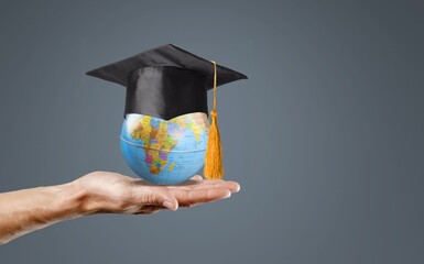 Graduation cap on Earth globe. study concept