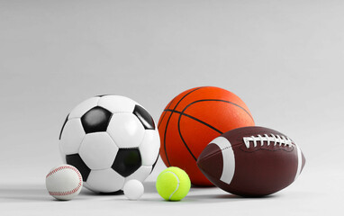 Many different sports balls on light gray background