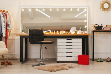 Makeup room. Stylish dressing table with mirror and chair