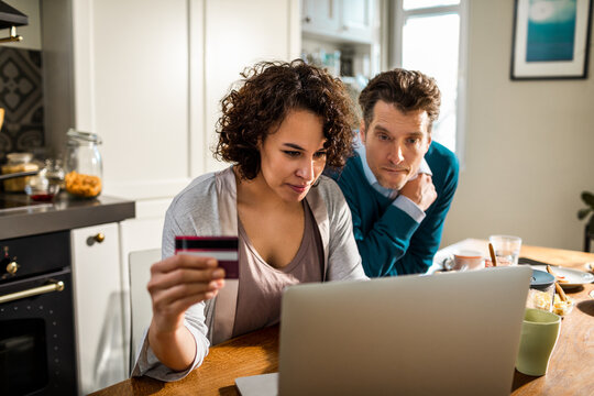 Couple using laptop to online shop from home