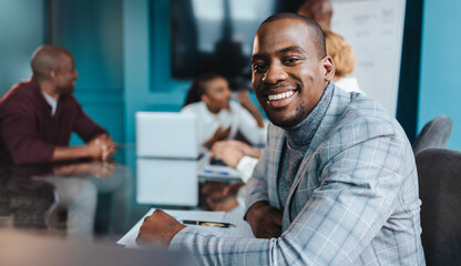 Young professional smiling and looking at camera in a successful business meeting