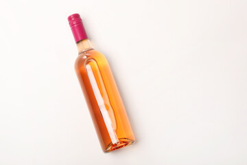 Bottle of expensive rose wine on white background, top view. Space for text