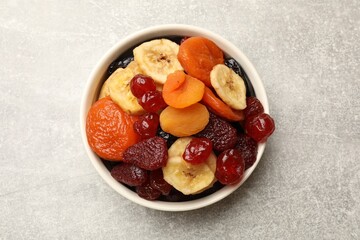 Mix of delicious dried fruits on grey table, top view