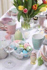 Festive table setting with painted eggs. Easter celebration