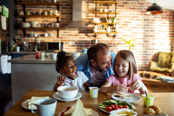 Diverse family enjoying breakfast together in a cozy kitchen setting
