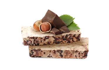 Tasty halva, pieces of chocolate, hazelnuts and green leaves isolated on white