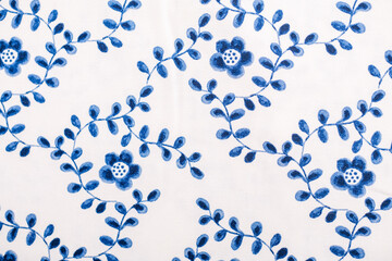  Beautiful embroidered textile featuring delicate blue flowers and leaves.